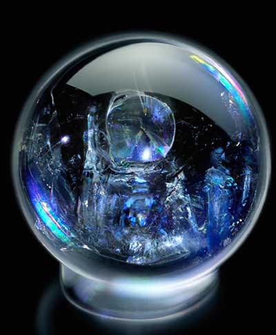 A crystal ball showcasing glimpses of advanced robots digital interfaces and interconnected systems